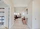 Bright hallway with light wood floors and a view into the carpeted living area and unique, rustic furniture at 3789 Shady Pointe Row, Greenwood, IN 46143