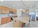 Well-lit kitchen with stainless steel appliances, granite countertops, and island seating at 3789 Shady Pointe Row, Greenwood, IN 46143