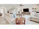 Bright living room with large TV, stylish furniture, and staircase access at 3789 Shady Pointe Row, Greenwood, IN 46143