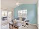Bright living room with a ceiling fan, a beige couch with throw pillows, and a sliding door with outdoor access at 3789 Shady Pointe Row, Greenwood, IN 46143