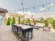Expansive patio features brick pavers, overhead string lights, and an outdoor dining set at 3789 Shady Pointe Row, Greenwood, IN 46143