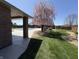 Beautiful backyard featuring a pool, manicured lawn, and a lovely flowering tree at 415 N Westview Dr, Columbus, IN 47201