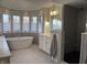 Luxurious bathroom with a modern tub, a tiled walk-in shower, and abundant natural light from large windows at 415 N Westview Dr, Columbus, IN 47201