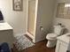 Well-lit bathroom features a shower, toilet, vanity, stylish rug, and framed artwork at 415 N Westview Dr, Columbus, IN 47201
