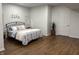 Spacious bedroom with luxury vinyl floors, neutral walls, and large bed with decorative pillows at 415 N Westview Dr, Columbus, IN 47201