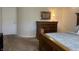 Comfortable bedroom features a wooden dresser, bedside lamp, and plush carpet creating a relaxing retreat at 415 N Westview Dr, Columbus, IN 47201