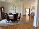 Formal dining area showcasing a round table with six chairs, hardwood flooring, and stylish chandelier at 415 N Westview Dr, Columbus, IN 47201