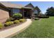Charming brick home entrance with a curved walkway and beautifully landscaped garden beds at 415 N Westview Dr, Columbus, IN 47201