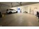 Spacious garage featuring epoxy flooring, car, plenty of room for storage and additional access door at 415 N Westview Dr, Columbus, IN 47201