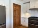 Bright kitchen with stainless steel oven, white cabinets, and wood-trimmed doors at 415 N Westview Dr, Columbus, IN 47201
