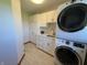 Well-lit laundry room with stacked washer and dryer and ample cabinet space at 415 N Westview Dr, Columbus, IN 47201