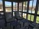 Inviting screened porch with comfortable seating, multiple tables, and a view of the outdoor pool at 415 N Westview Dr, Columbus, IN 47201