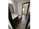 Well-lit bathroom with a modern sink, geometric wallpaper, and updated fixtures at 4506 Phoenix Dr, Indianapolis, IN 46241