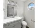 Well-lit bathroom featuring a modern vanity, octagon window, and sleek fixtures at 4630 Kelvington Dr, Indianapolis, IN 46254