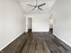 Minimalist bedroom with hardwood floors, ceiling fan, and walk-in closet doorway at 4630 Kelvington Dr, Indianapolis, IN 46254