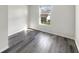 Bright bedroom with hardwood floors and a view of the neighborhood at 4630 Kelvington Dr, Indianapolis, IN 46254