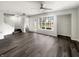 Open-concept living room with hardwood floors, a staircase, and a view to the home's exterior at 4630 Kelvington Dr, Indianapolis, IN 46254