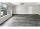 Bright living room featuring hardwood floors, a ceiling fan, and a large window for natural light at 4630 Kelvington Dr, Indianapolis, IN 46254