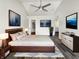 Serene primary bedroom featuring sleek flooring, a modern ceiling fan, and elegant décor at 4630 Kelvington Dr, Indianapolis, IN 46254