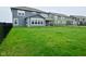 Spacious backyard with black fence, showcasing the rear of the house with a covered patio at 5181 Golden Grove Dr, McCordsville, IN 46055