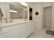 Bright bathroom featuring a double vanity sink, framed mirror and marble floors at 5181 Golden Grove Dr, McCordsville, IN 46055