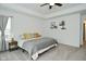 Well-lit bedroom with tray ceiling, neutral colors, a ceiling fan, and minimalist decor at 5181 Golden Grove Dr, McCordsville, IN 46055