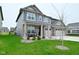 Charming two-story home boasts a three-car garage and a covered front porch at 5181 Golden Grove Dr, McCordsville, IN 46055
