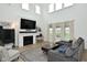 Bright living room boasts a fireplace, large windows, and gray sectional sofa at 5181 Golden Grove Dr, McCordsville, IN 46055