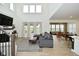 Spacious living room features a fireplace, tall windows and open-concept floor plan at 5181 Golden Grove Dr, McCordsville, IN 46055