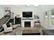 Cozy living room featuring a fireplace, dark cabinet, and a modern staircase at 5181 Golden Grove Dr, McCordsville, IN 46055