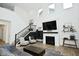 Spacious living room featuring fireplace, stairwell, and natural lighting at 5181 Golden Grove Dr, McCordsville, IN 46055