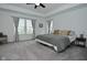 Spacious main bedroom featuring a ceiling fan and tray ceiling, large windows, and neutral decor at 5181 Golden Grove Dr, McCordsville, IN 46055