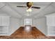 Spacious attic featuring hardwood floors, built-in shelving, and natural light at 52 N Oakland Ave, Indianapolis, IN 46201