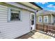 Cozy back porch with a dog door for easy pet access and a side view of the home at 52 N Oakland Ave, Indianapolis, IN 46201