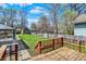 Spacious backyard with a lush green lawn, shed, and wooden deck, perfect for outdoor activities at 52 N Oakland Ave, Indianapolis, IN 46201