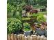 Landscaped backyard with a serene pond, lush greenery, and decorative flower pots adding to the natural beauty at 52 N Oakland Ave, Indianapolis, IN 46201