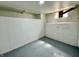 Basement with painted block walls and floor, and small window at 52 N Oakland Ave, Indianapolis, IN 46201