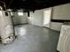 Basement featuring a water tank, painted floors, and laundry hookups at 52 N Oakland Ave, Indianapolis, IN 46201