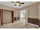 Cozy bedroom featuring neutral walls, ceiling fan, and closet at 52 N Oakland Ave, Indianapolis, IN 46201