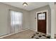 Entryway with patterned floor tiles, carpet, and natural light through the window at 52 N Oakland Ave, Indianapolis, IN 46201