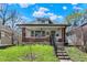 Charming home featuring brick accents, a welcoming porch, and a well-manicured lawn at 52 N Oakland Ave, Indianapolis, IN 46201