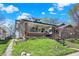 Landscaped front yard leading up to a charming home with a welcoming entryway at 52 N Oakland Ave, Indianapolis, IN 46201