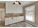 Bright kitchen offers ample cabinetry, a window, and tiled flooring for an efficient cooking space at 52 N Oakland Ave, Indianapolis, IN 46201