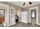 Bright kitchen with built-in shelves, updated appliances, ceiling fan, and access to multiple rooms at 52 N Oakland Ave, Indianapolis, IN 46201