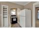 The kitchen features a stove, refrigerator, and built-in shelving for ample storage and convenience at 52 N Oakland Ave, Indianapolis, IN 46201