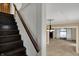 Dark wood staircase with living room view featuring decorative pendant light at 52 N Oakland Ave, Indianapolis, IN 46201