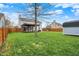 Large backyard with green grass, patio, shed, pergola, and privacy fence at 5223 Jerry Ct, Indianapolis, IN 46254