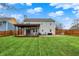 Spacious backyard with lush green grass, pergola covered deck, and patio at 5223 Jerry Ct, Indianapolis, IN 46254