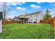 A large backyard with a pergola covered deck area and a wooden fence at 5223 Jerry Ct, Indianapolis, IN 46254