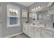 Bright bathroom with a double sink vanity, cabinets, and natural light from the window at 5223 Jerry Ct, Indianapolis, IN 46254